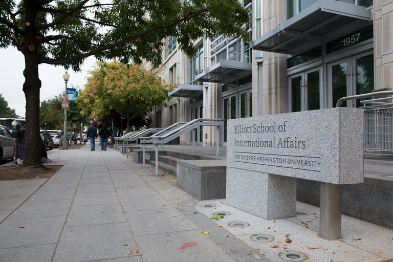 Exterior view of Elliot School of International Affairs and large sign. 