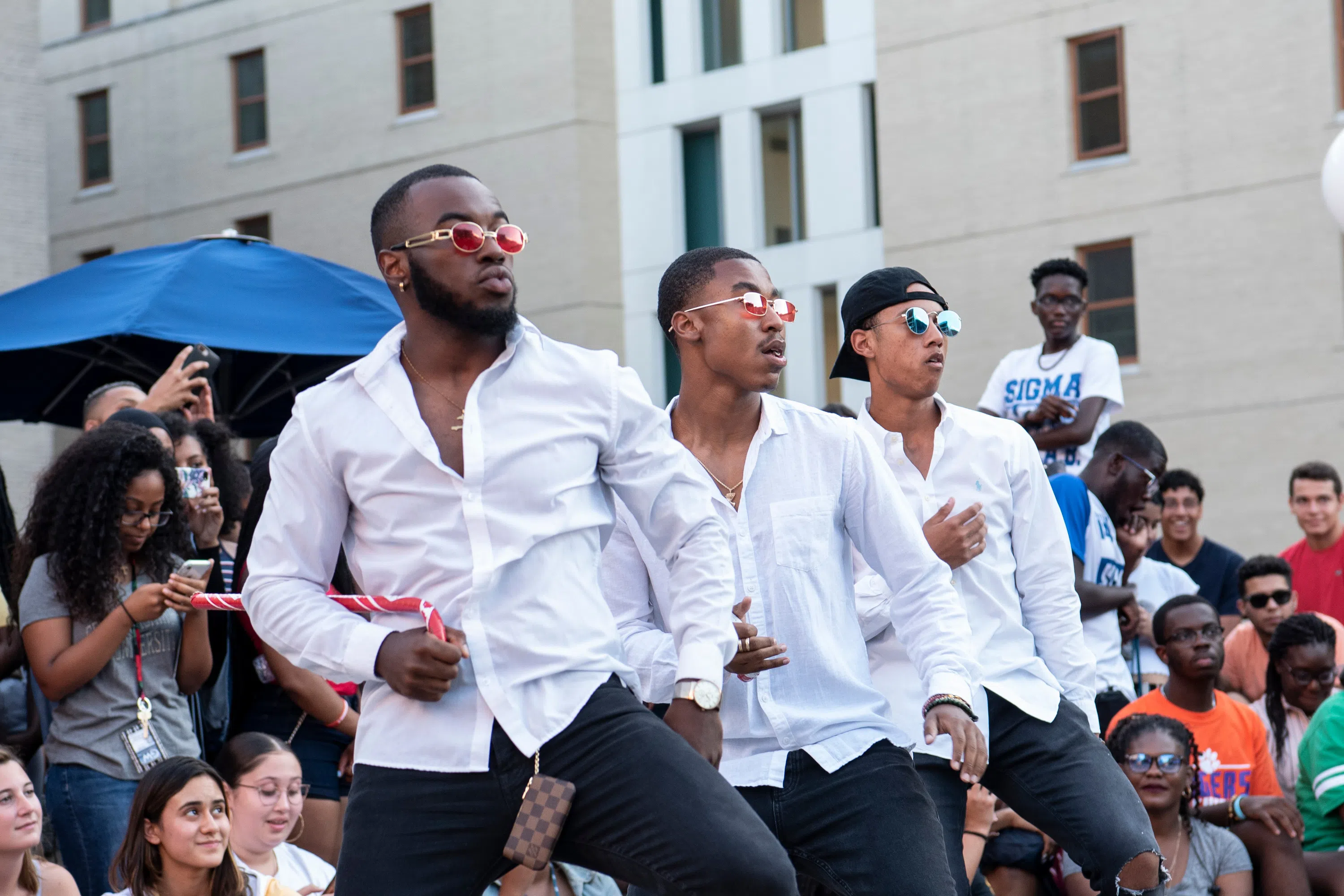 Students in a fraternity dance at a block party
