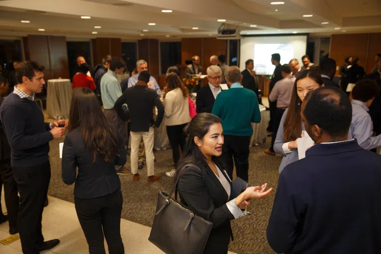 Student and staff mingling inside of the City View Room.