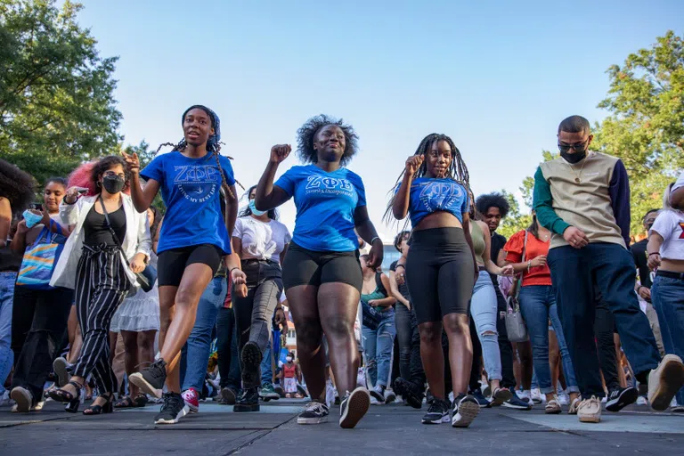 Students, sororities and fraternities dance outside at a block party. 