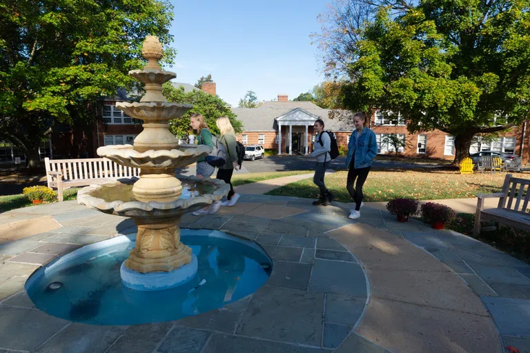 Students standing around an outdoor fountain