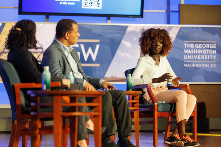 An interview between three people on stage at the Elliott School of International Affairs.