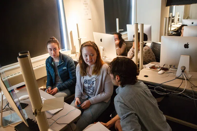 Students collaborating with computers