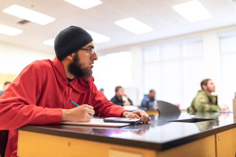 Student takes notes during a lecture 