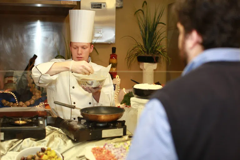 Chef prepares meal for guest at the McCorkle Café