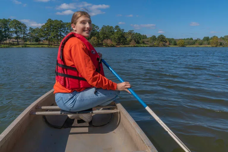 Student in a canoe on Paris Lake