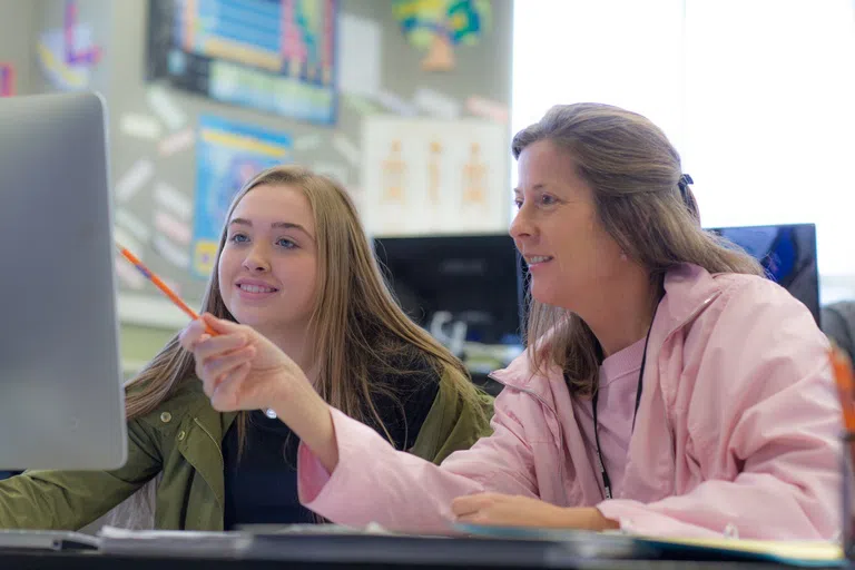 Student receives help from a staff member at the Tutorial Center. 