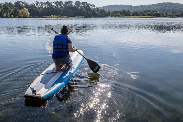 Person paddle boards on Paris Lake