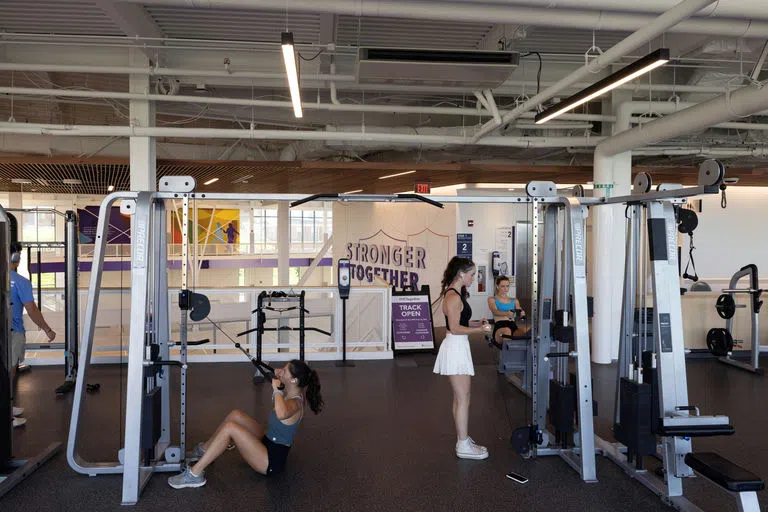 Students using workout machinery in The Jo