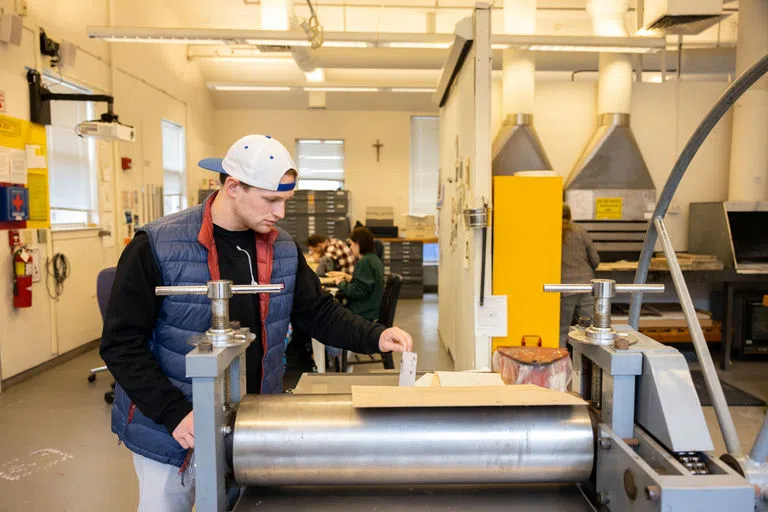 Student working with machine in studio 