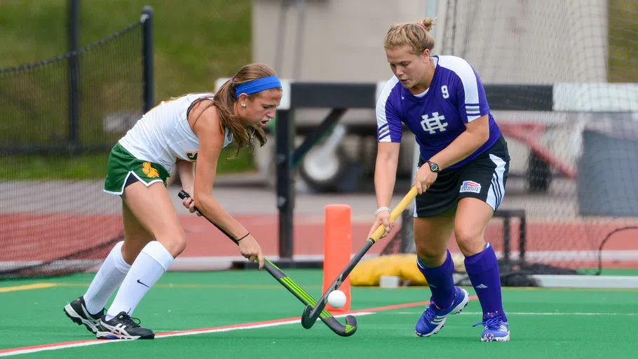 Field hockey athlete competing on the field 