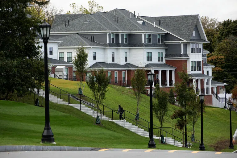 Student going up the stairs to the townhouses