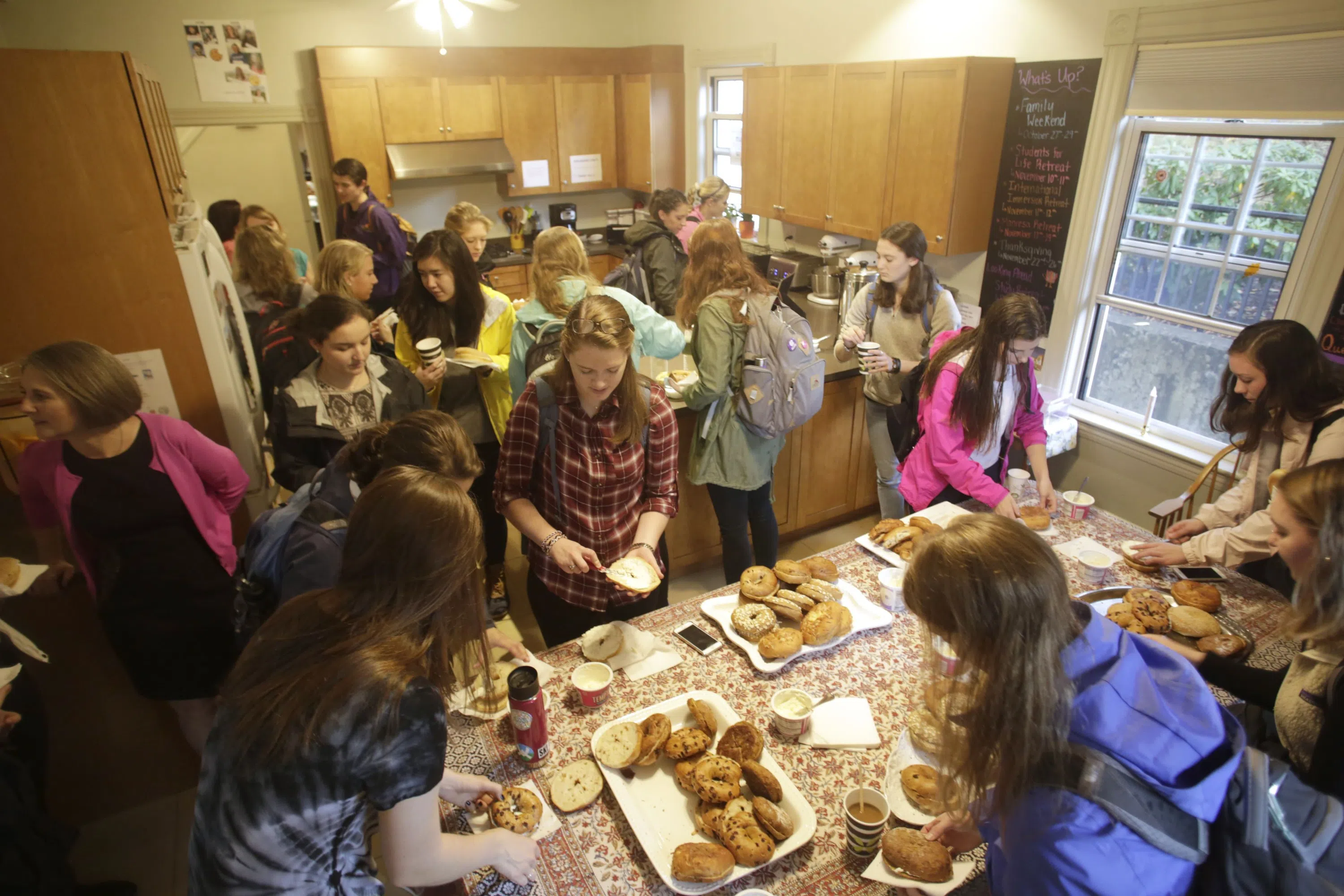 students line up for bagels inside building 