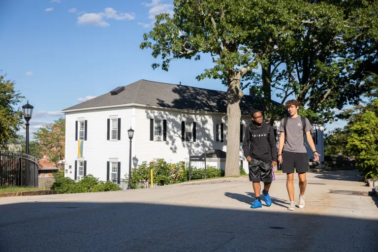 students walking by building