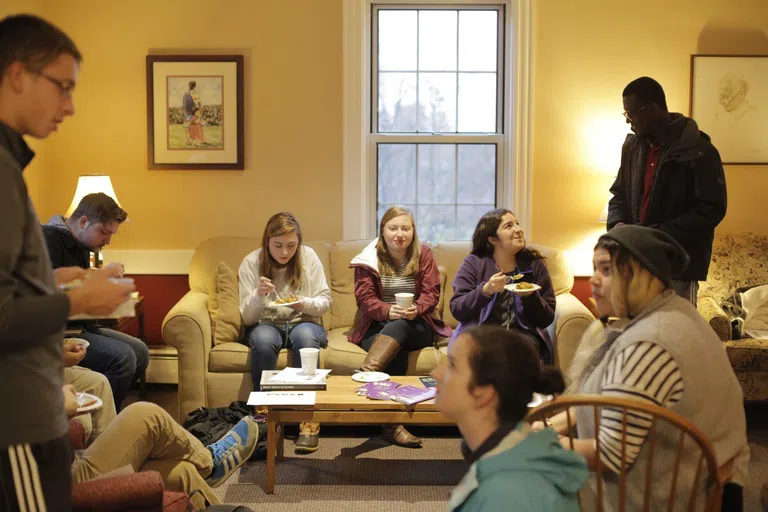 students eating dinner inside building