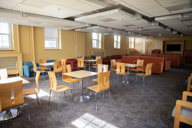 Tables and couches in Wheeler Hall common room 