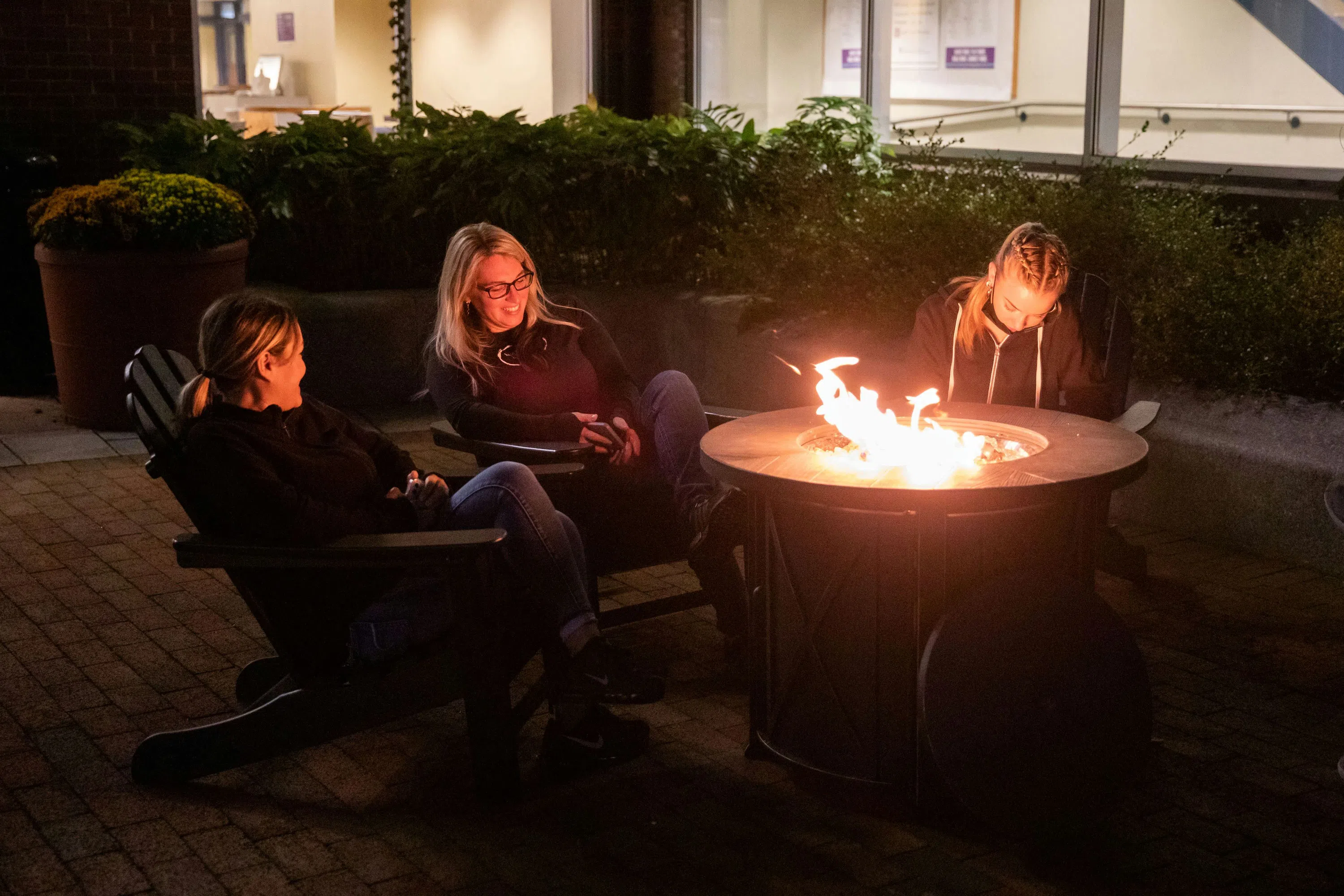 Students outside hogan at a firepit 