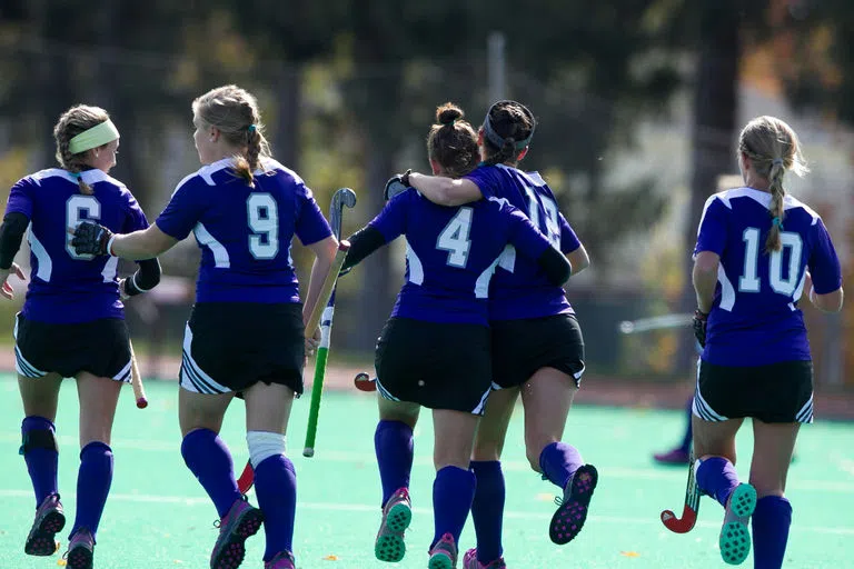 Student field hockey athletes on the field 