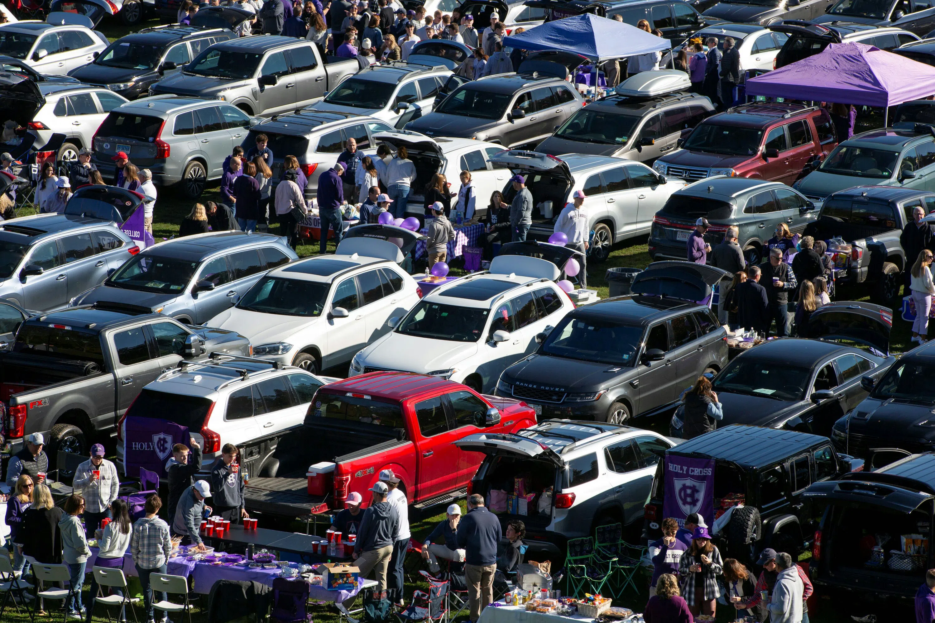 Rows of cars tailgating on the baseball field 
