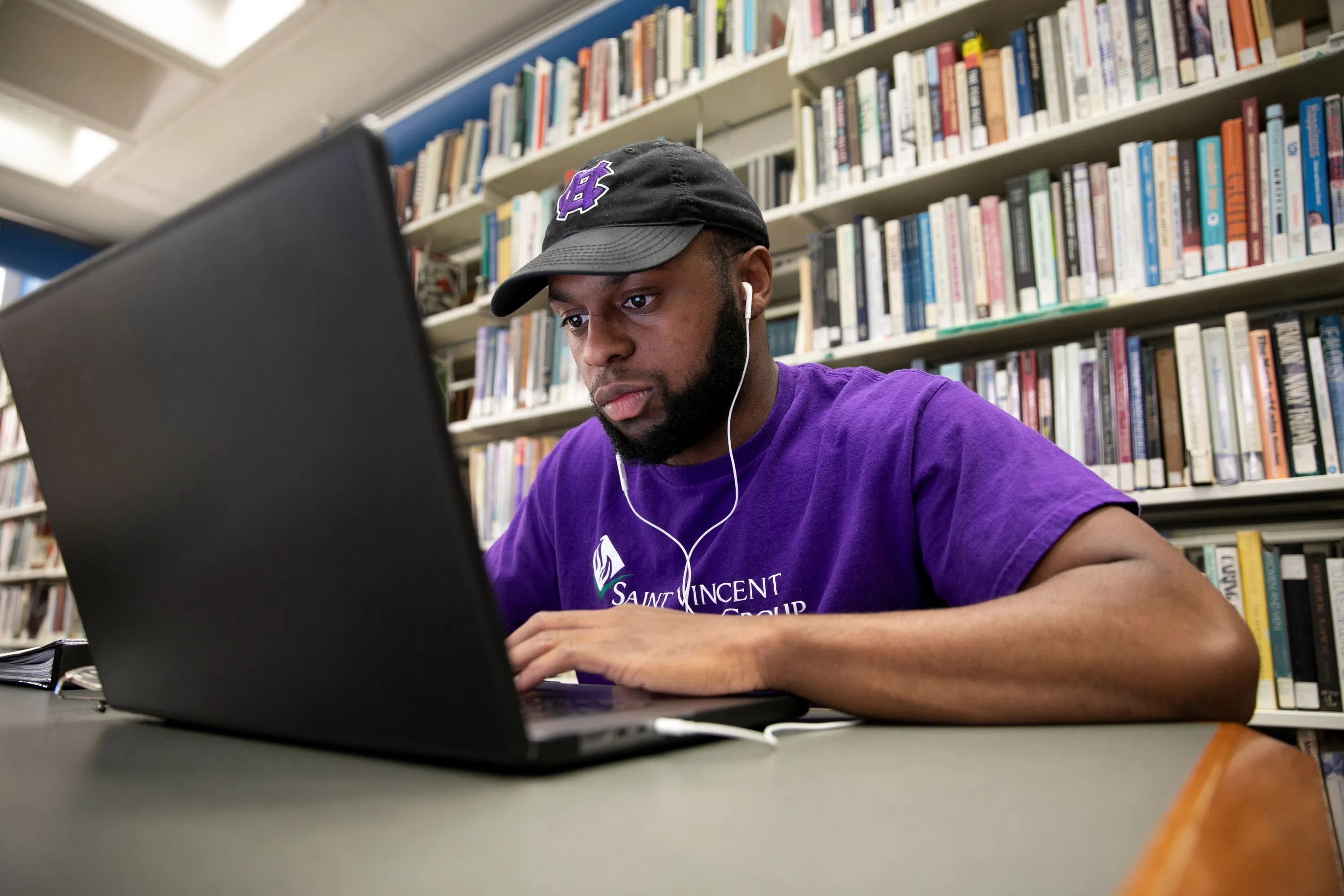 student working on laptop at library