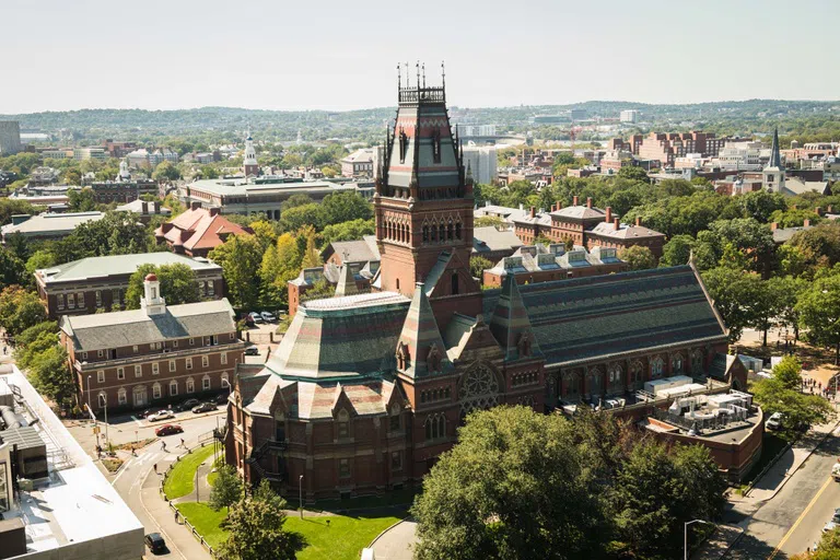 Aerial view of Memorial Hall, a Gothic architecture styled building, amidst the setting of Cambridge