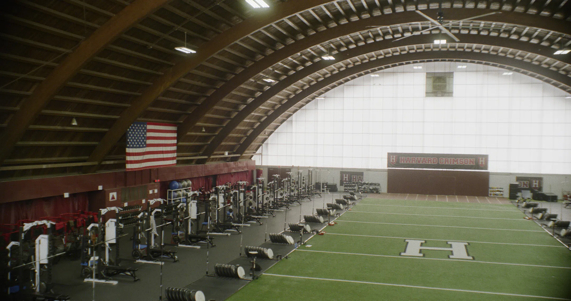 Domed weight room with weight-lifting benches lined up