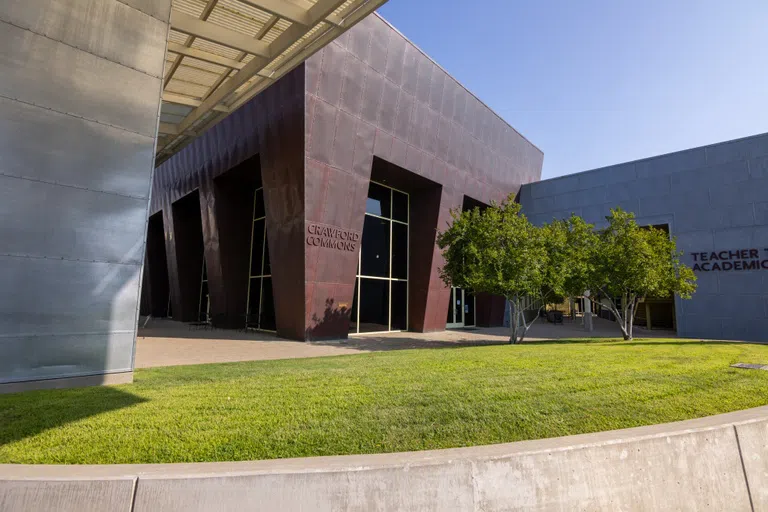 Exterior of Crawford Commons with green grass and unique architecture