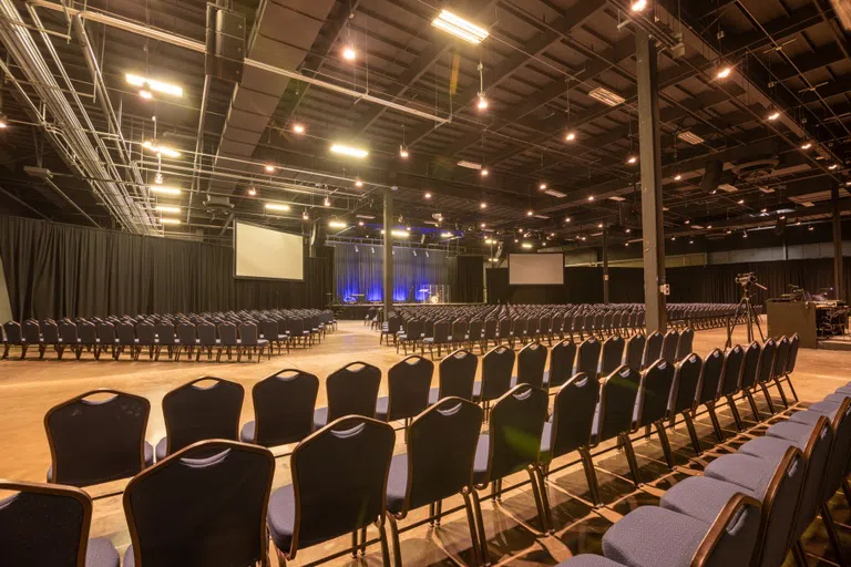 Plenty of rows of seating with stage in the distance