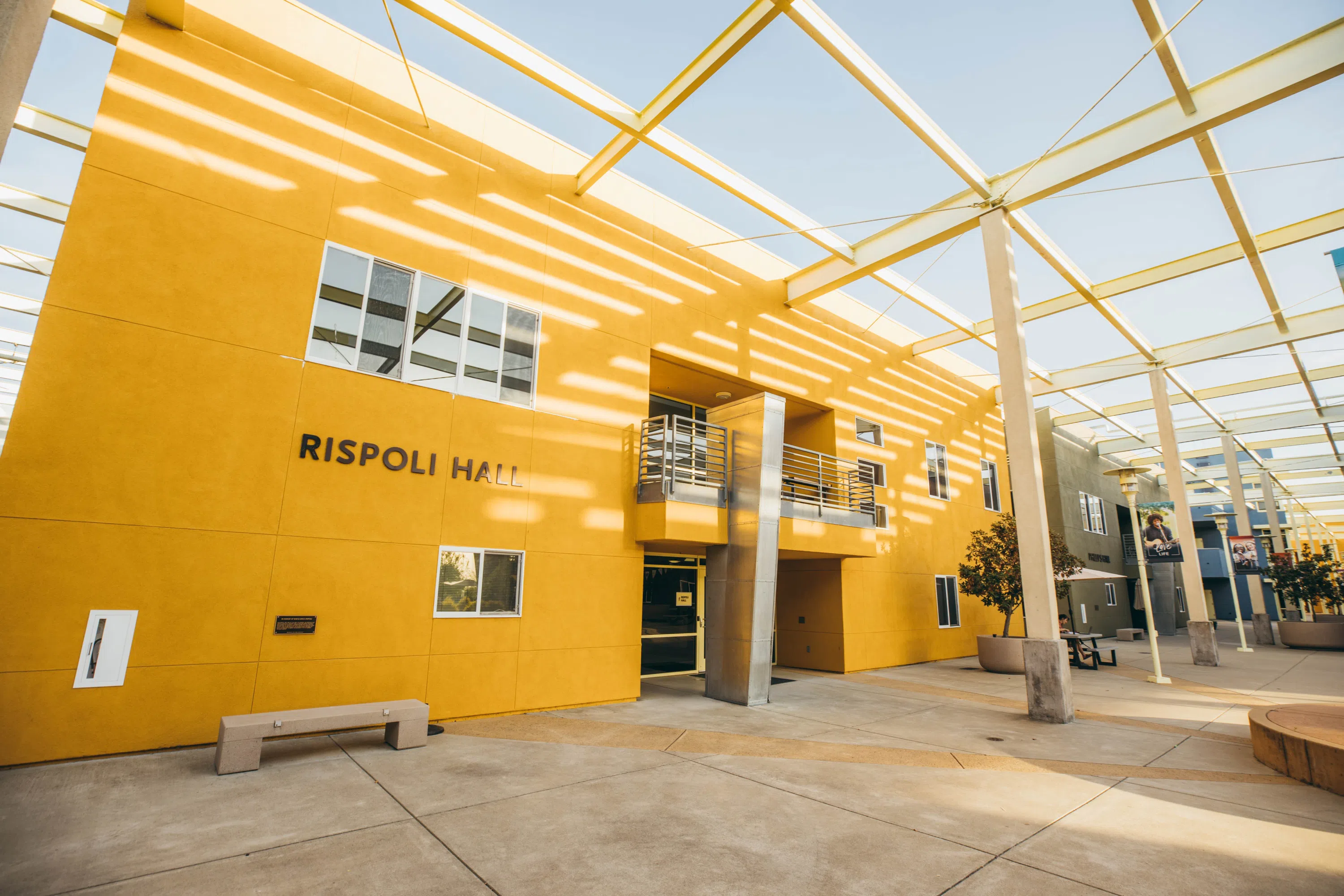 Exterior of Rispoli Hall with patio space and architectural features 