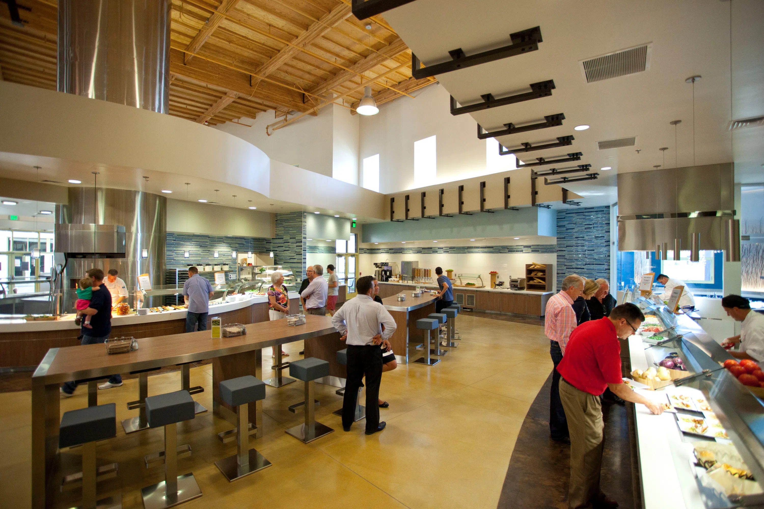 Wide view of the kitchen with staff attending to trays 