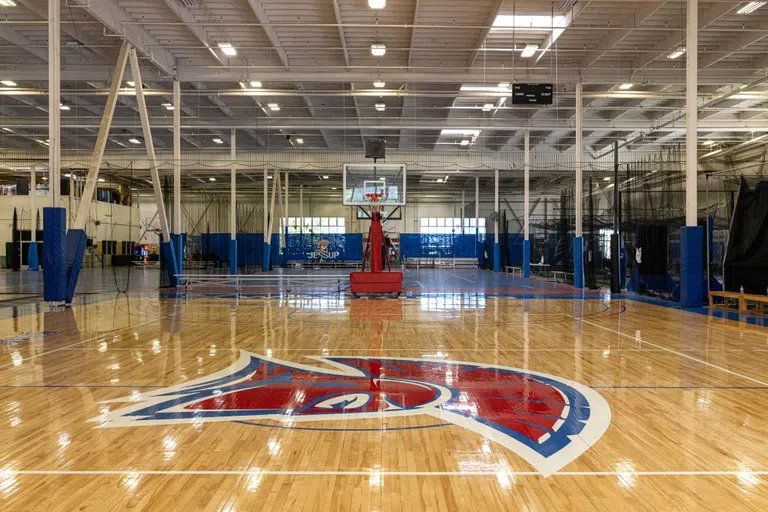 Indoor basketball court with Jessup mascot painted on floor