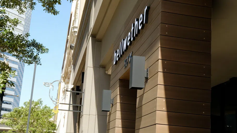 A storefront with a sheep logo attached the outer wall.