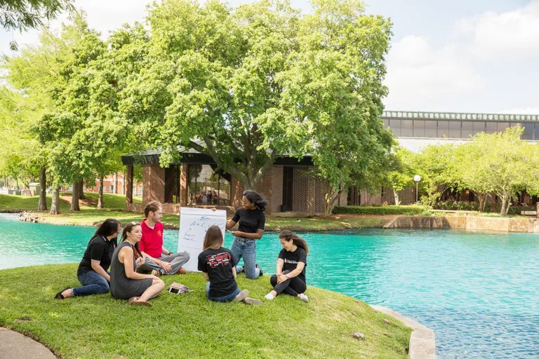 Students Studying by Pond