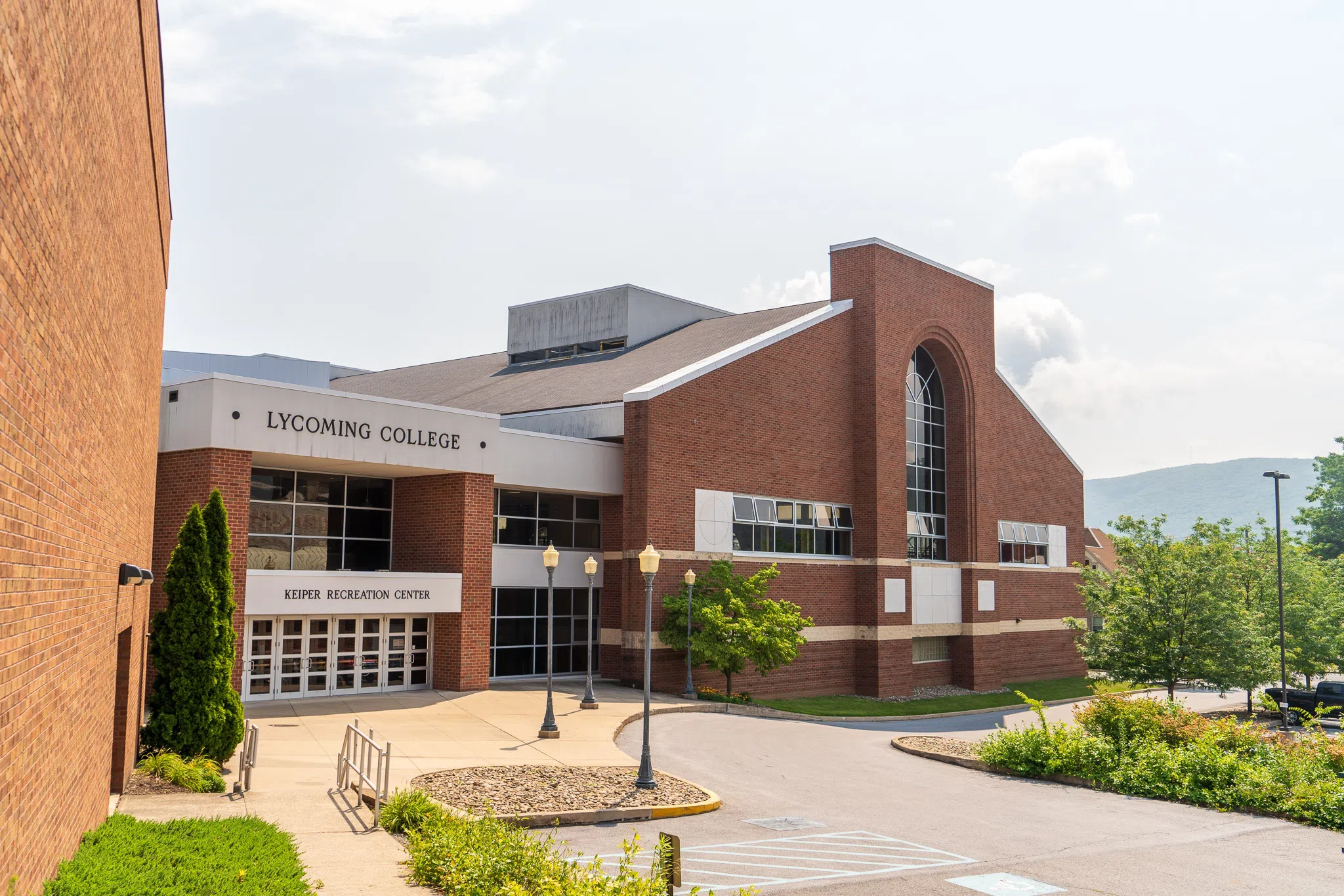 A view of the Keiper Recreation Center & Lamade Gymnasium in July with the mountains of Williamsport in the background.