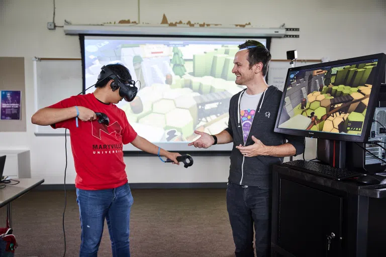 A student within the Game Design program tests some of the equipment used within the program. 