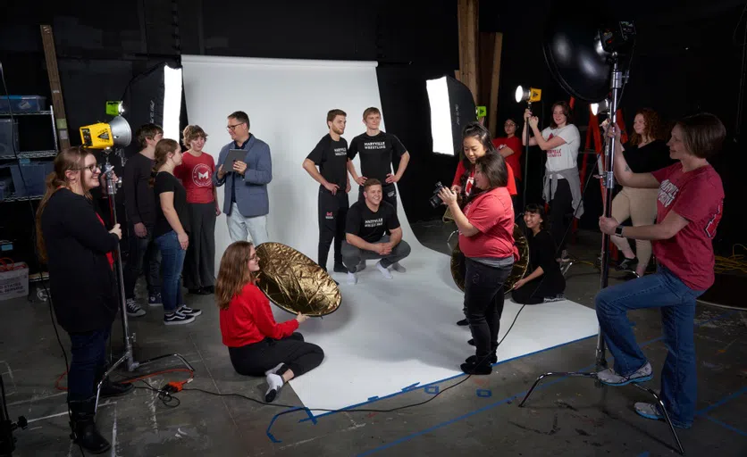 A group of students gather for a photoshoot. 