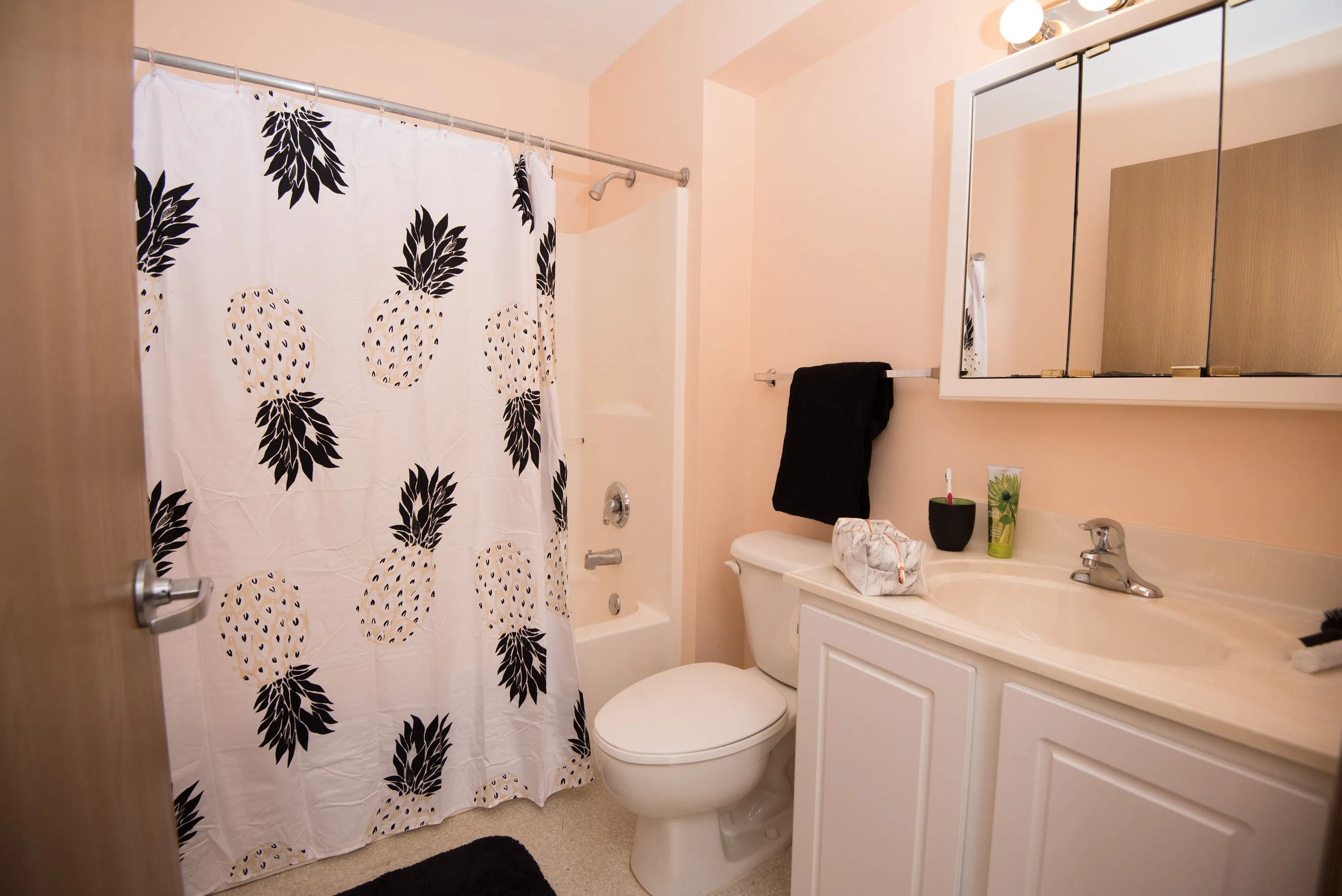 Each bathroom has a shower/tub, toilet, and sink area.