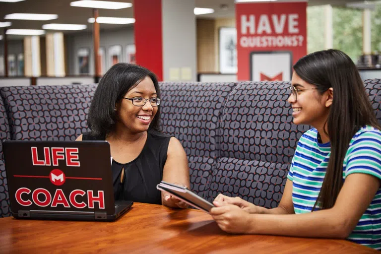 A student meets with her life coach.