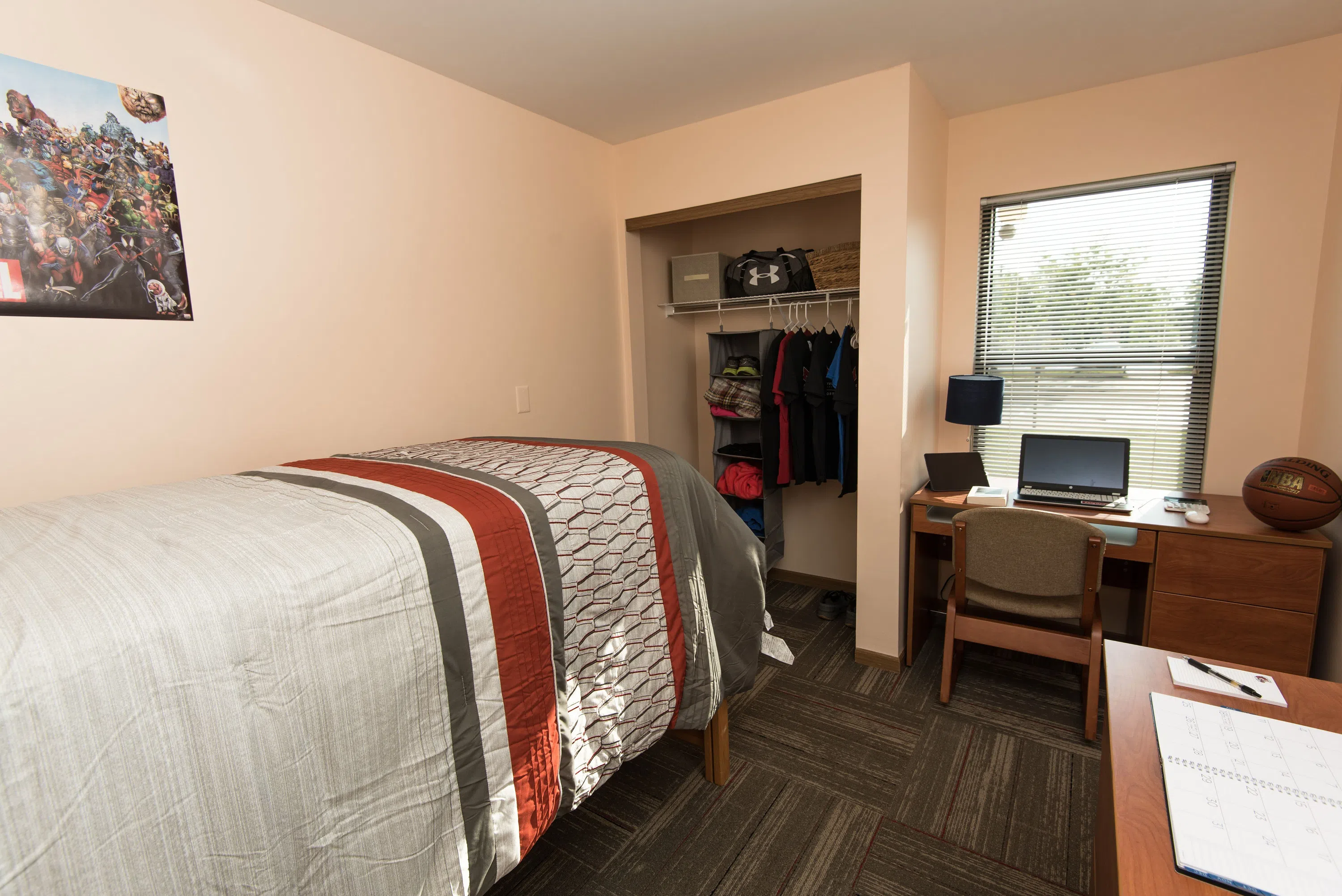 A look into the Apartment bedrooms and bathrooms. Each room has a closet, bed, desk, chair, and set of drawers.