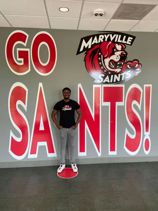 A student stands in as the "I" in SAINTS 