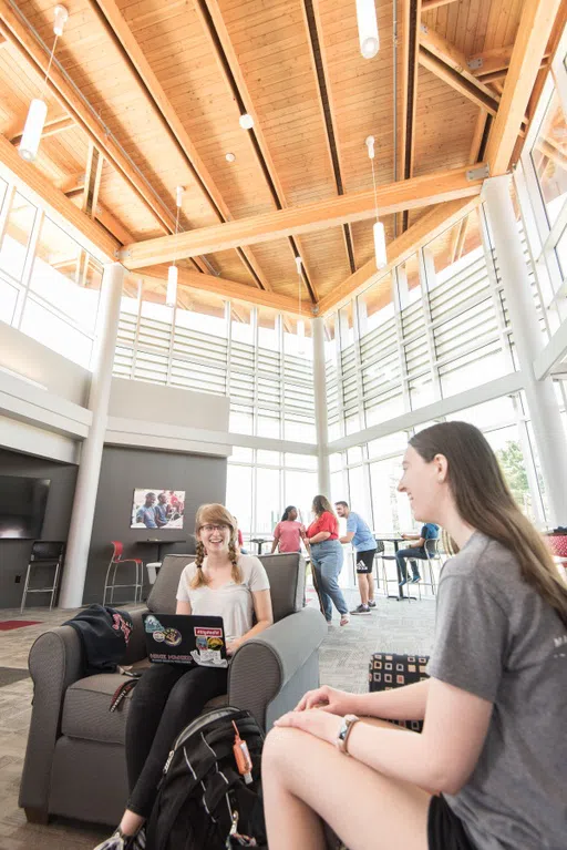 Students spend time in the "lodge," the main lobby in Saints Hall, playing pool, sitting by the fireplace, and chatting on the couches.