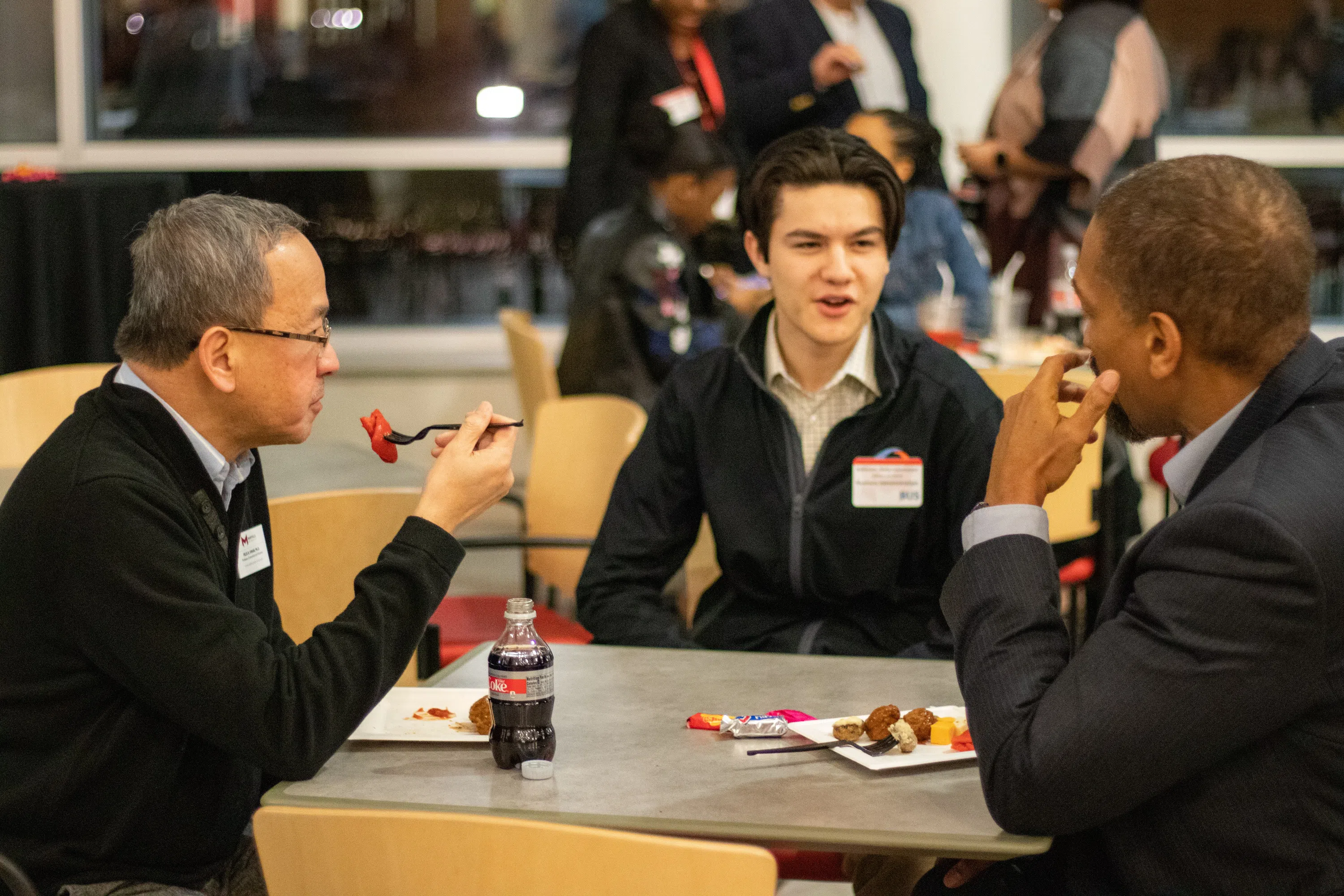 Faculty and students share a meal in the dining hall.