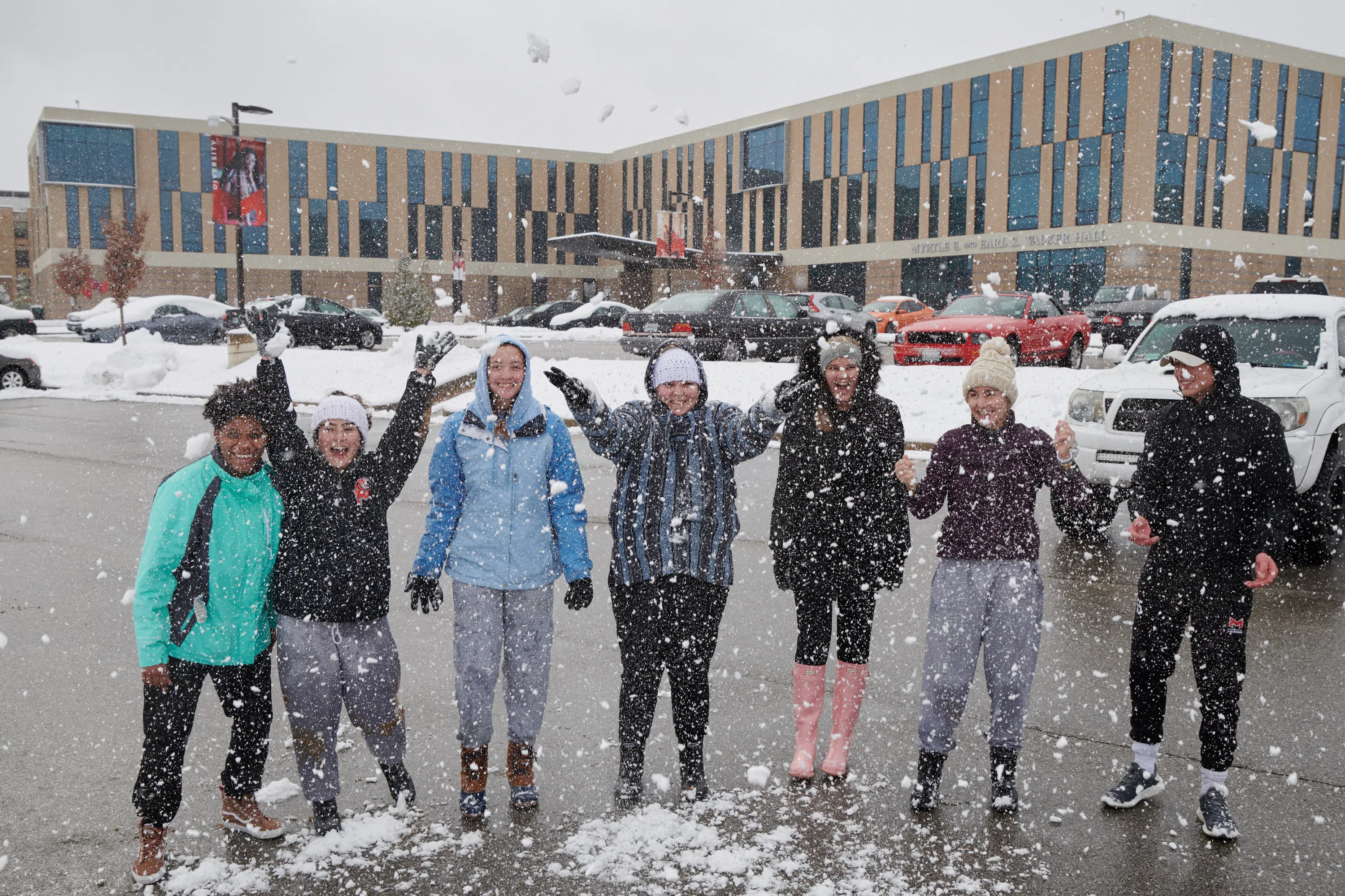 Students play in the snow behind Walker Hall before hitting the hill for a little snowboarding!