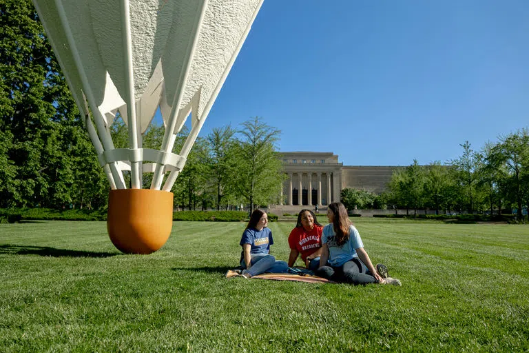 Students sit on the lawn outside of the Nelson Atkins Art Museum