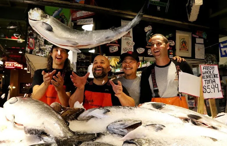 Fish mongers throwing fish to one another 