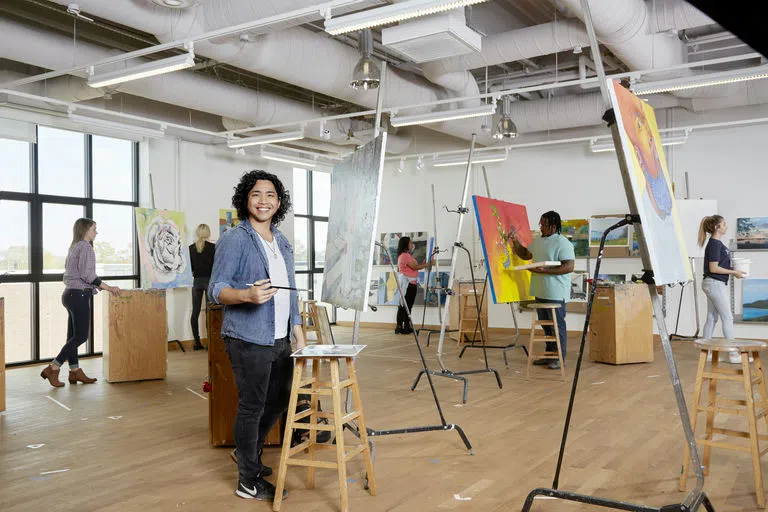 Student poses in the arts studio