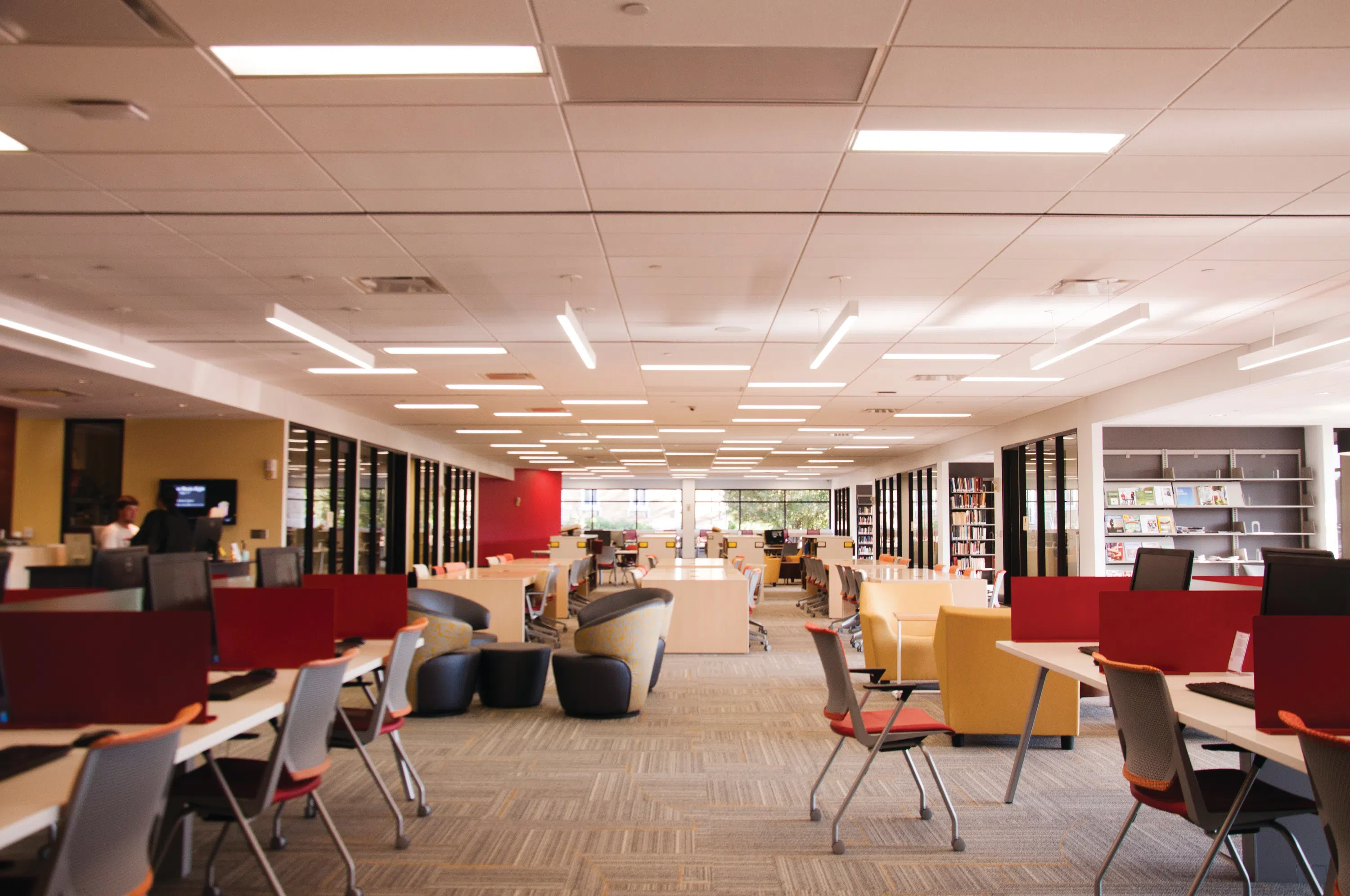 A view of inside Gangwish library. Students have access to computers, study areas, and lounge chairs for socializing.