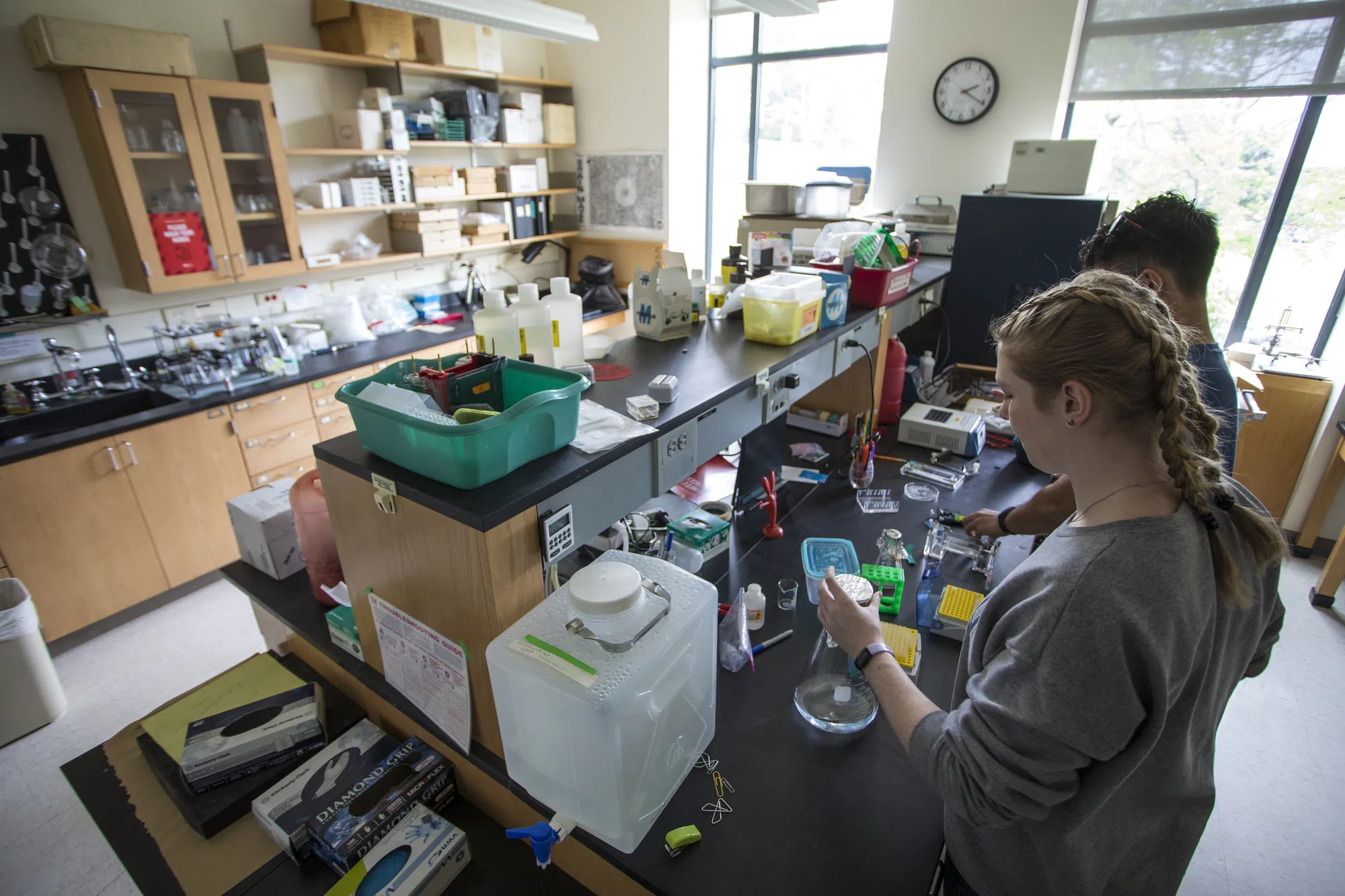 Two students conduct research in a chemistry lab.