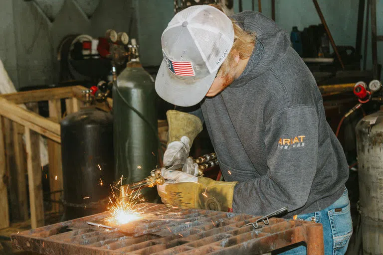 Student welding inside the Industrial Technology Building