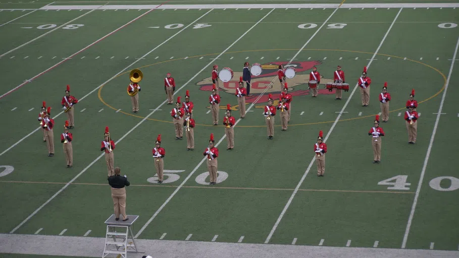 Marching band performing in the middle of Memorial Stadium's field.